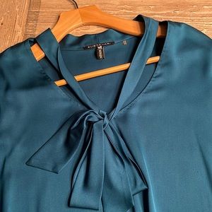 Teal silk pussy bow blouse with detailed buttons on sleeve